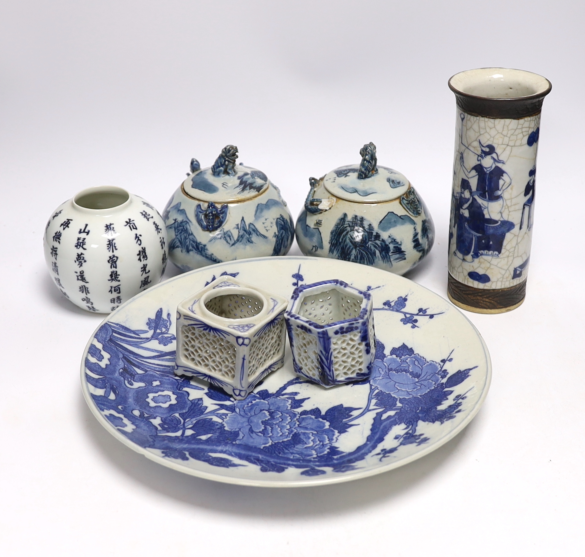 A Japanese blue and white wall plate, a pair of Chinese jars and covers, cylindrical crackle glaze vase and others, largest 31cm in diameter (7)